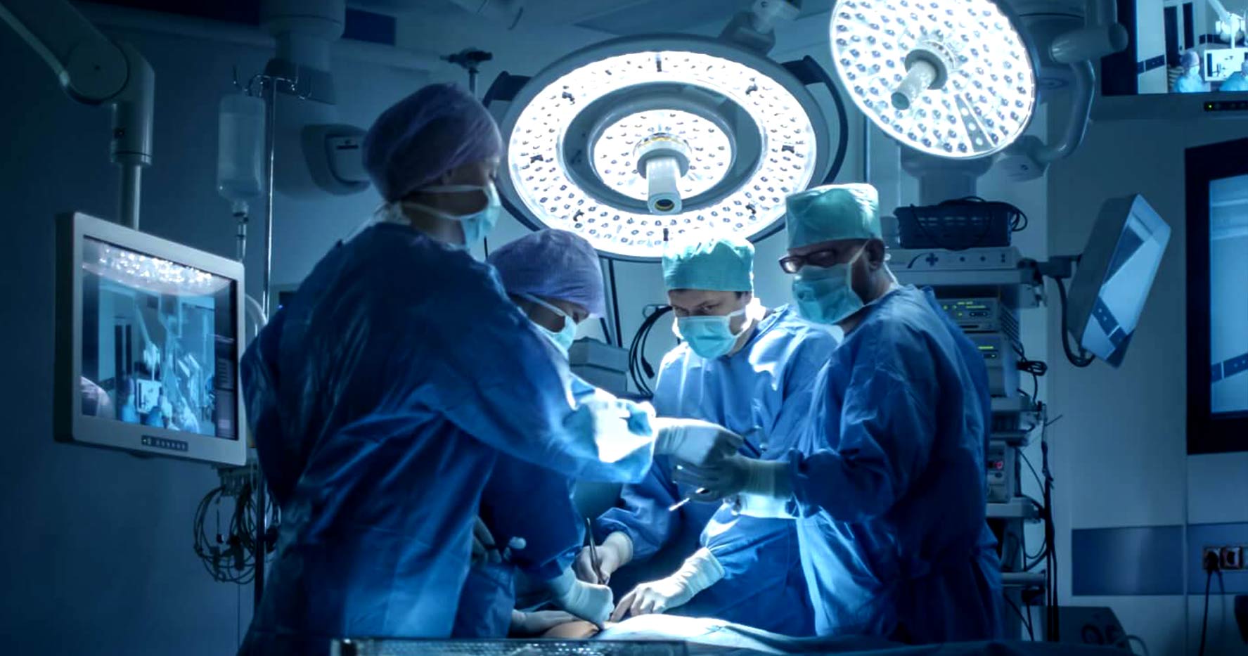 surgeons working in operating room